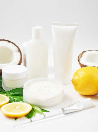 Natural organic homemade cosmetics with lemon and coconut. Skin care. Spa salon and treatments. Beautician background. Clay, lemon, beauty products, tropical summer concept. Flat lay, copy space.の写真素材