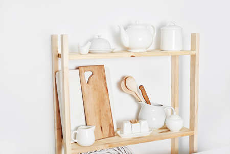 Kitchen utensils, tools, chef accessories and dishware on wooden shelf. Kitchen rustic interior. Home kitchen decor concept. Copy space. Contemporary kitchenware background.の写真素材