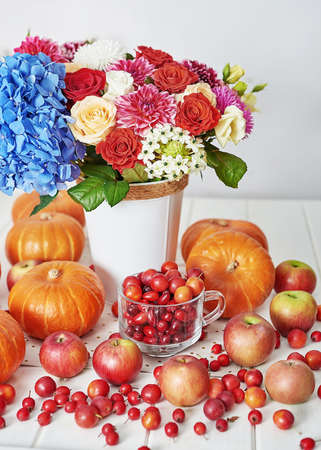 Autumn harvest pumpkin background. Pumpkins, apples and flowers on table. Thanksgiving table. Copy space. Halloween or seasonal autumnal. Design mock up. Greeting card. Fall kitchenの写真素材