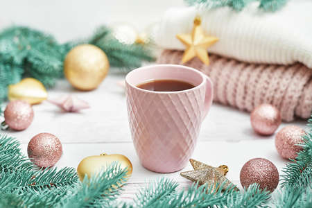 Christmas table setting. Cup of coffee or tea on background of Christmas tree. Christmastime celebration. Winter Holidays. Xmas mock up. Greeting card templateの写真素材
