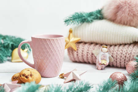 Christmas table setting. Cup of coffee or tea on background of Christmas tree. Christmastime celebration. Winter Holidays. Xmas mock up. Greeting card templateの写真素材