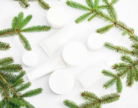 Christmas Beauty cosmetic products sale background. Flat lay composition with makeup products and fir branches on white background. Skin Care & Spa Products. Copy spaceの写真素材