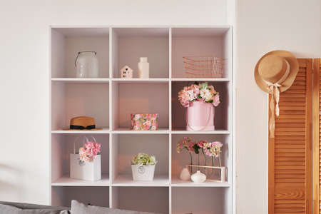 Pink living room. Studio apartment. loft interior. Shelves and decor in the room. Rent and delivery...