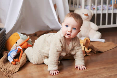 Newborn 6 months boy sitting and playing with educational toys. happy motherhood and fatherhood....