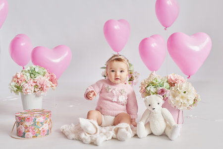 Valentine Baby girl. Valentine's Day. Balls and flowers. celebration. mother's day postcard. International day of happiness. birthday party.の写真素材