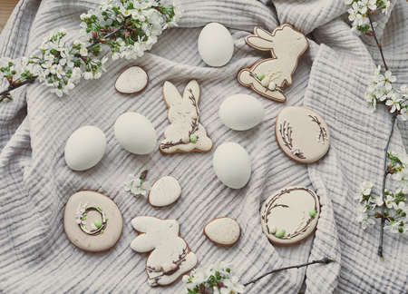 Celebration and holiday of Easter. Easter bunny, gingerbread, eggs, flowering twigs postcard....