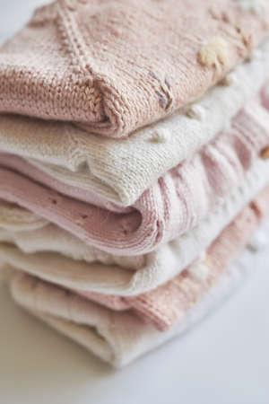 Stack of knitted clothes. baby clothes. Needlework, hobby, knitting, handwork