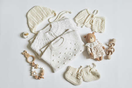 Children's knitwear. Jumper, hat, boots, socks. Wooden teether, nipple. baby shower party. Preparing...