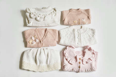Stack of knitted clothes. baby clothes. Needlework, hobby, knitting, handwork.