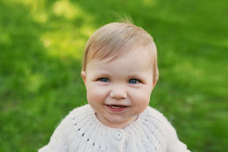 Smiling baby boy on grass in park. Children Protection Day. World Children's Day.の写真素材
