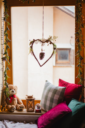 Cushion and teddy bear on the window in the roomの写真素材