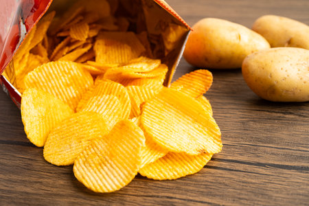 Potato chips fried snack fast food in open bag.の写真素材