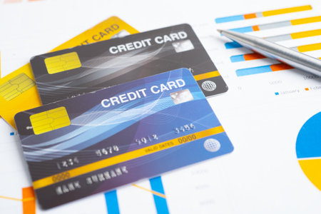 Credit card with US dollar banknotes on graph. Finance business and trading.