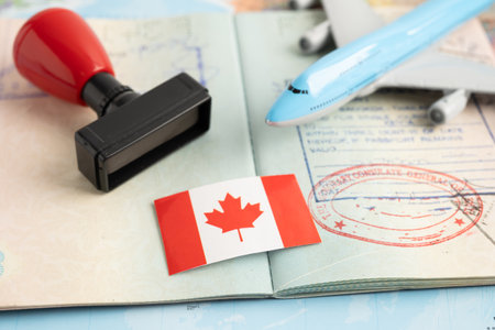 Canada flag with approved Stamp visa and passport document to immigration at airport in country.の写真素材