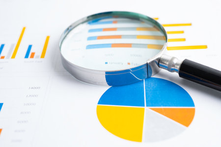 Magnifying glass  on graph. Finance business and trading.の写真素材