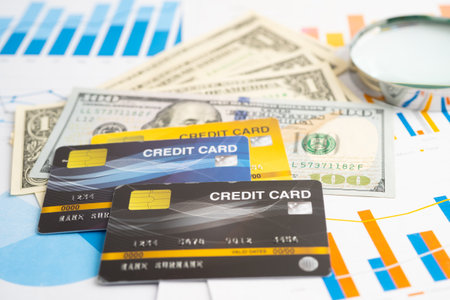 Credit card with US dollar banknotes on graph. Finance business and trading.の写真素材