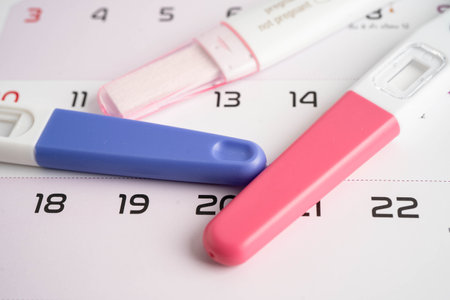 Pregnancy test on calendar, contraception health and medicine.の写真素材