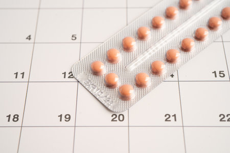 Birth control pills on calendar, contraception health and medicine.