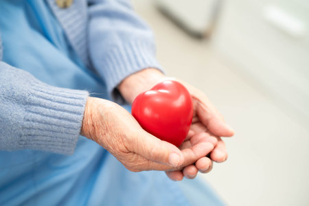 Asian doctor give red heart to elderly woman in her hand, heart Attack.の写真素材