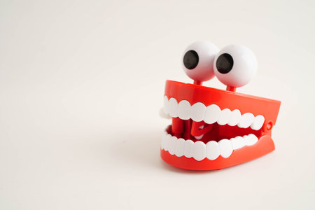 Funny red teeth with eye toy denture model for dental health care.