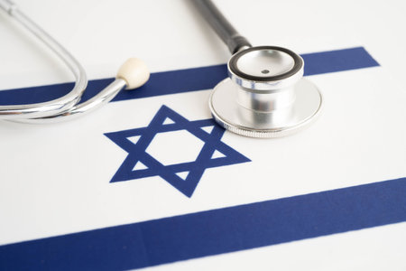 Israel flag with black stethoscope, Business and finance concept.の写真素材