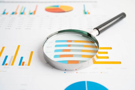 Magnifying glass on charts graphs paper. Financial development, Banking Account, Statistics, Investment Analytic research data economy.の写真素材