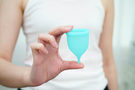 Asian woman holding à¸enstrual cup for hygiene menstrual period cycle protection.の写真素材