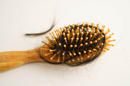 Asian woman have problem with long hair loss to comb brush.