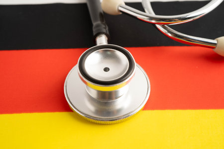 Germany flag with black stethoscope, Business and finance concept.の写真素材