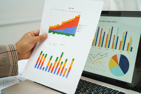 Asian business woman working with financial graph.