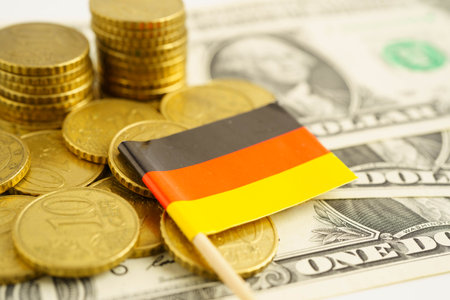 Germany flag on coin and banknote money, finance trading investment business currency concept.の写真素材