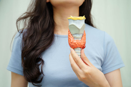 Hyperthyroidism, Overactive Thyroid, Thyroid Lymphoma, Asian woman with thyroid gland human anatomy model.の写真素材