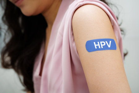 HPV, Human papilloma virus, Asian young woman receiving vaccine with blue bandage.の写真素材