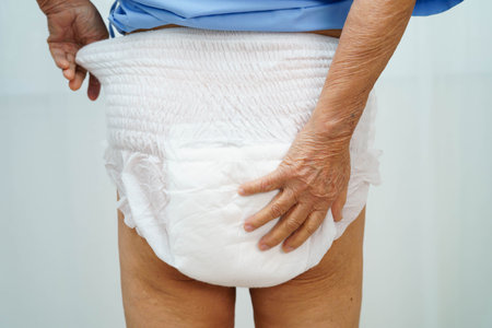 Asian senior woman patient wearing adult incontinence diaper pad in hospital.の写真素材