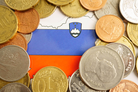 Slovenia flag on coins background, finance and accounting, banking concept.の写真素材