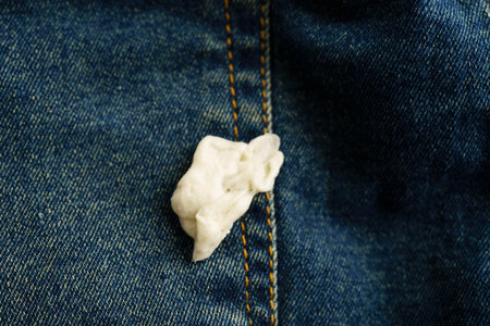 Dirty chewing gum stain removal on cloth jean accident to wash with washing powder, cleaning housework.の写真素材