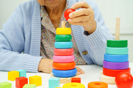 Asian elderly woman playing skill board game.の写真素材