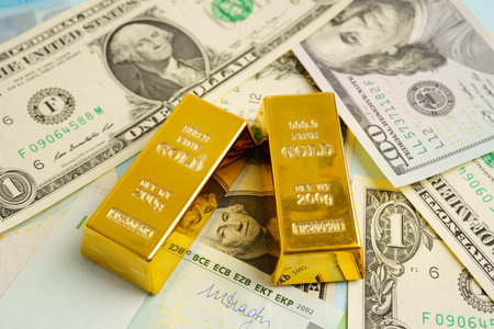 Gold bars with US dollar and Euro banknote money, finance trading investment business currency...