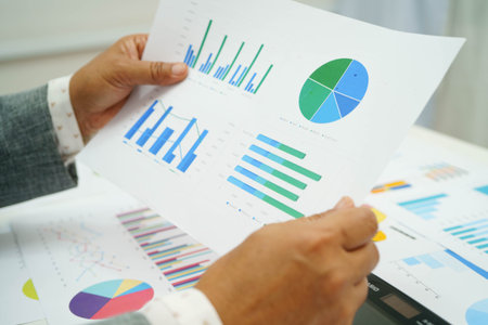 Asian business woman working with financial graph.