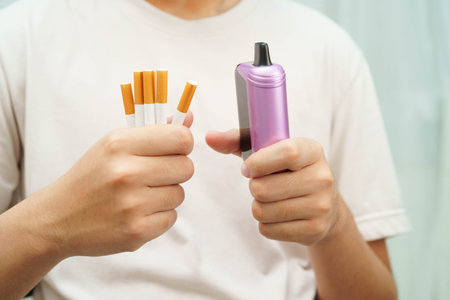 Man holding electronic cigarettes, no smoking.