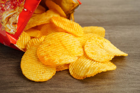 Potato chips, delicious BBQ seasoning spicy for chips, thin slice deep fried snack fast food.