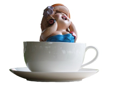 a little girl in a cup of teaの写真素材