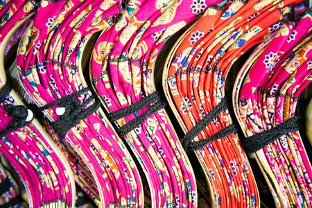 Colorful Thai Fans arranged for sale in a store in Thailandの写真素材