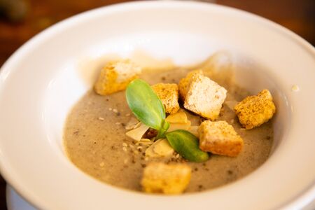 Pumpkin soup with biscuits in a white dishの写真素材