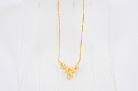 Gold chain necklace isolated on white background.の写真素材