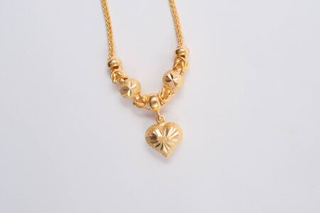 Gold chain necklace isolated on white background.