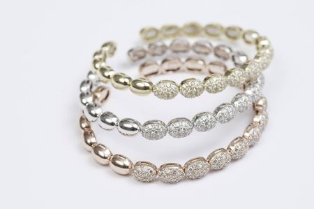 Set of three colored gold and diamond bracelets.