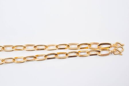 Gold chain necklace isolated on white background.