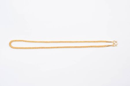 Gold chain necklace isolated on white background.の写真素材