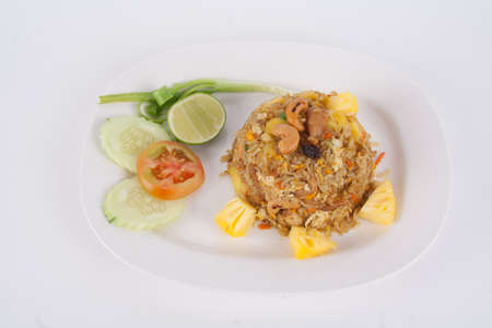 Fried rice with seafood served in a pineapple isolated on white backgroundの写真素材